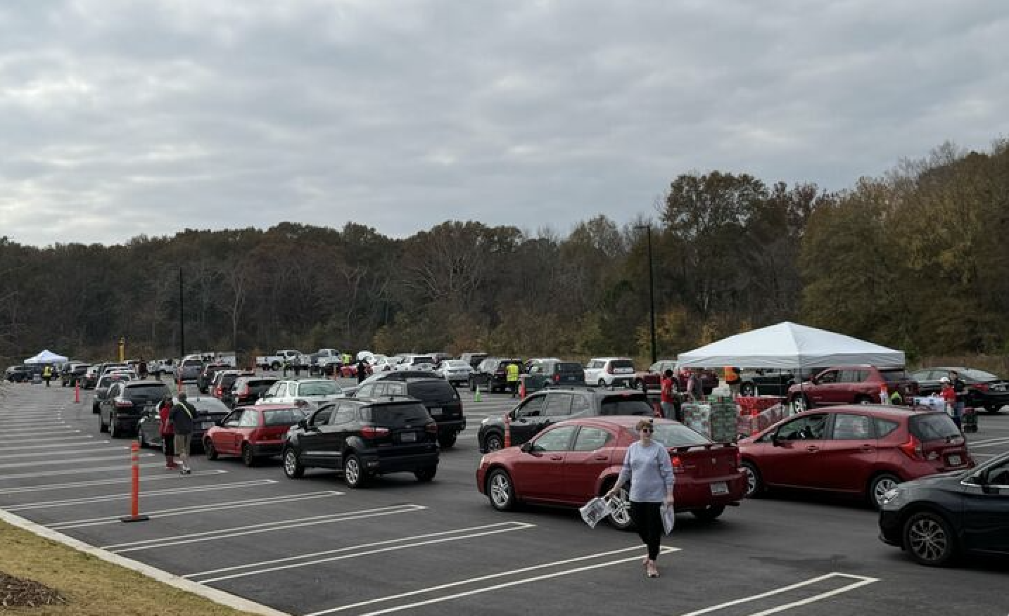 Photo of cars in line in a parking lot.